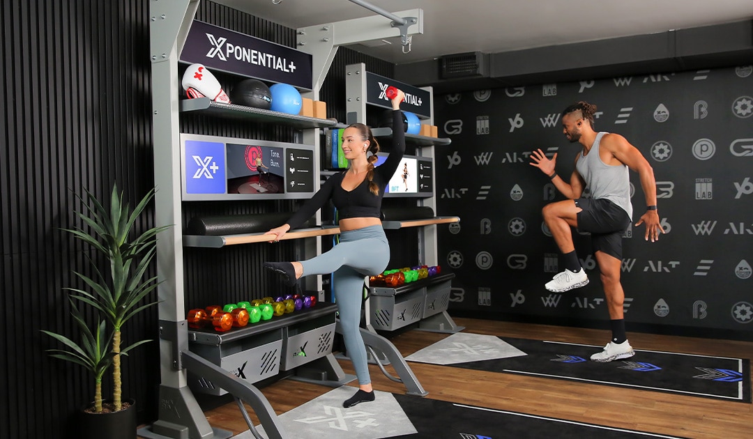 Two people working out with a digital fitness program
