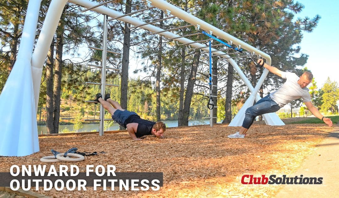 two people working out on an outdoor fitness structure