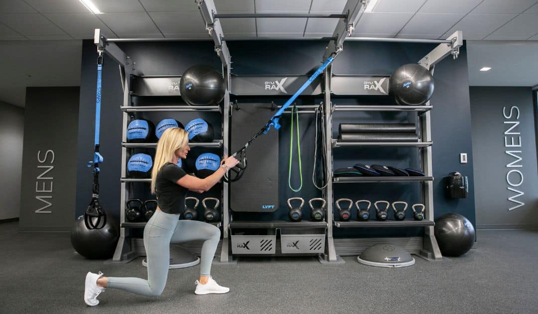 Women working out in hotel gym designed with trending equipment. 