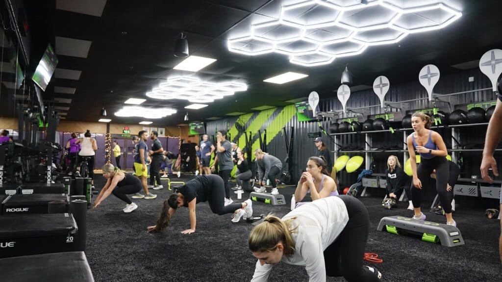 group of people working out together at the gym