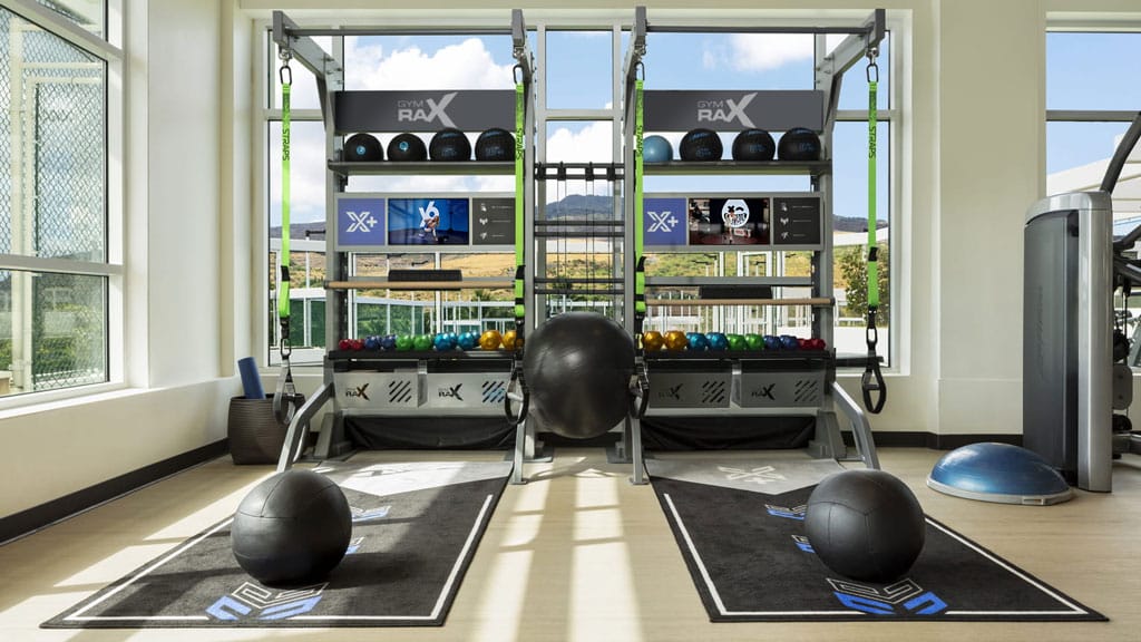 Two people working out on Xponential+ Training Bays.